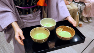 person holding tea cups on a tray