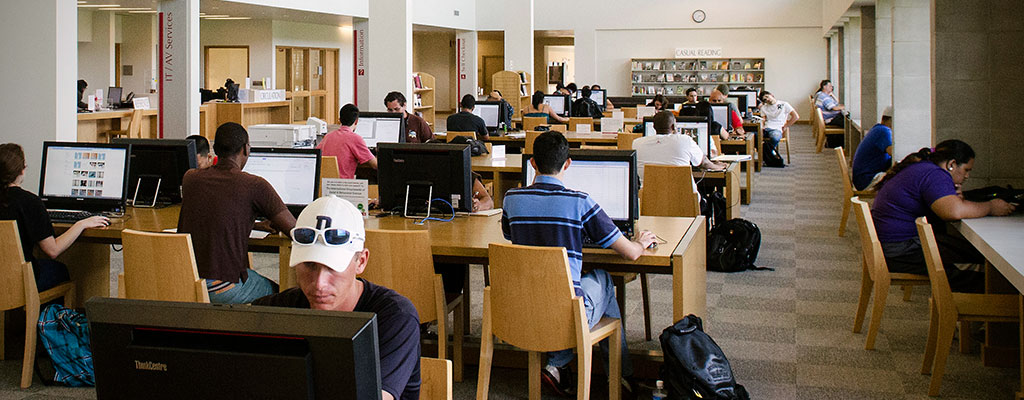 students at computers in a library